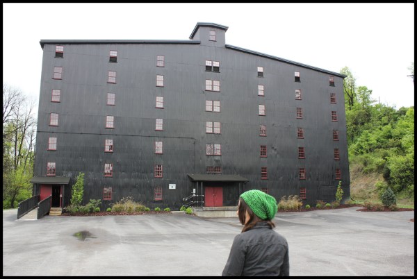 It's painted black as a preemptive aesthetic strike against the black mold that grows everywhere whiskey is distilled. Though not knowing that, I admit it looks like an enormous whorehouse.